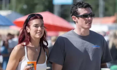 Dua Lipa sparks engagement rumors with Callum Turner after being spotted with a ring. Fans await official confirmation.